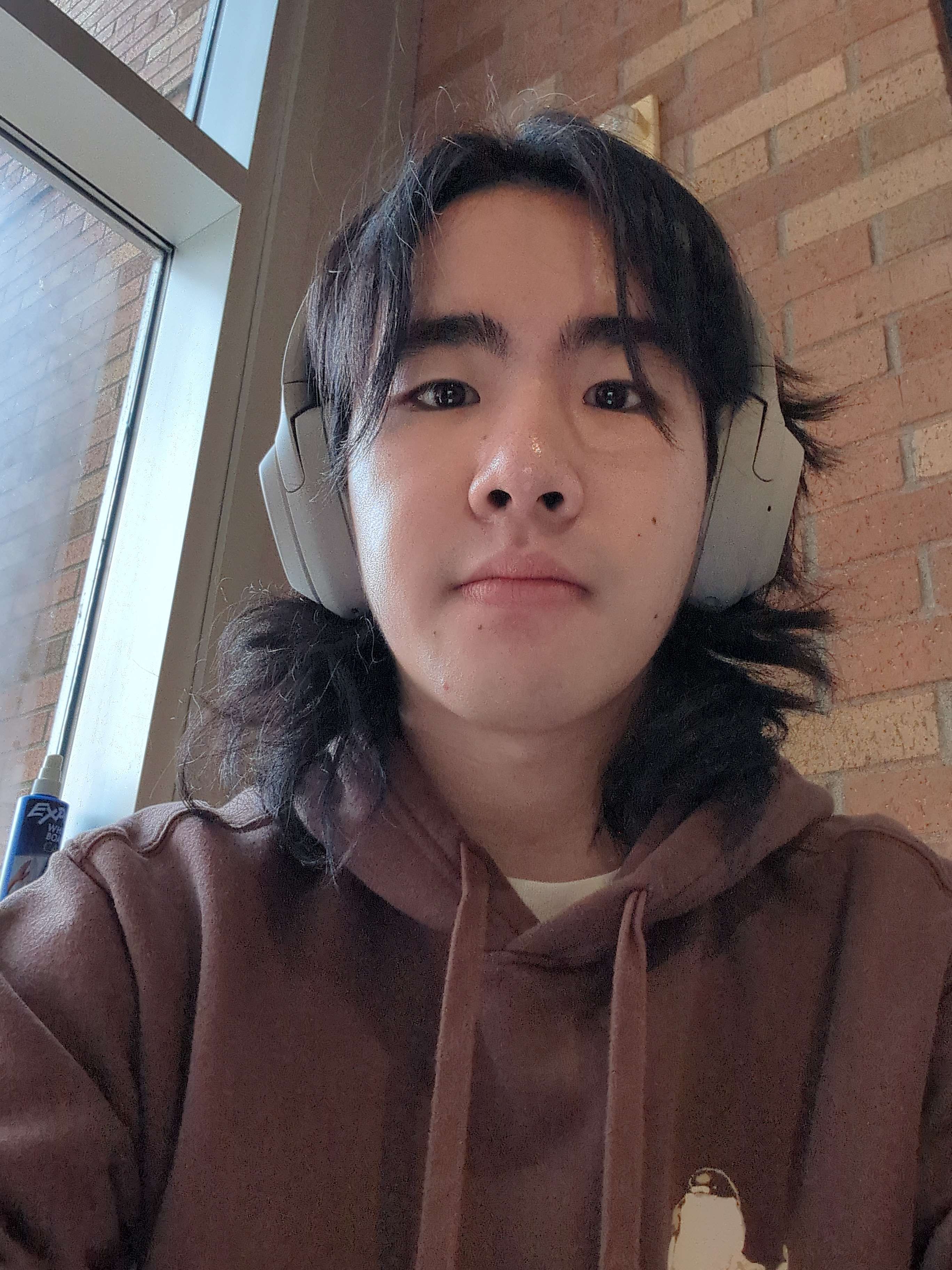 Chris with headphones and a studying face.